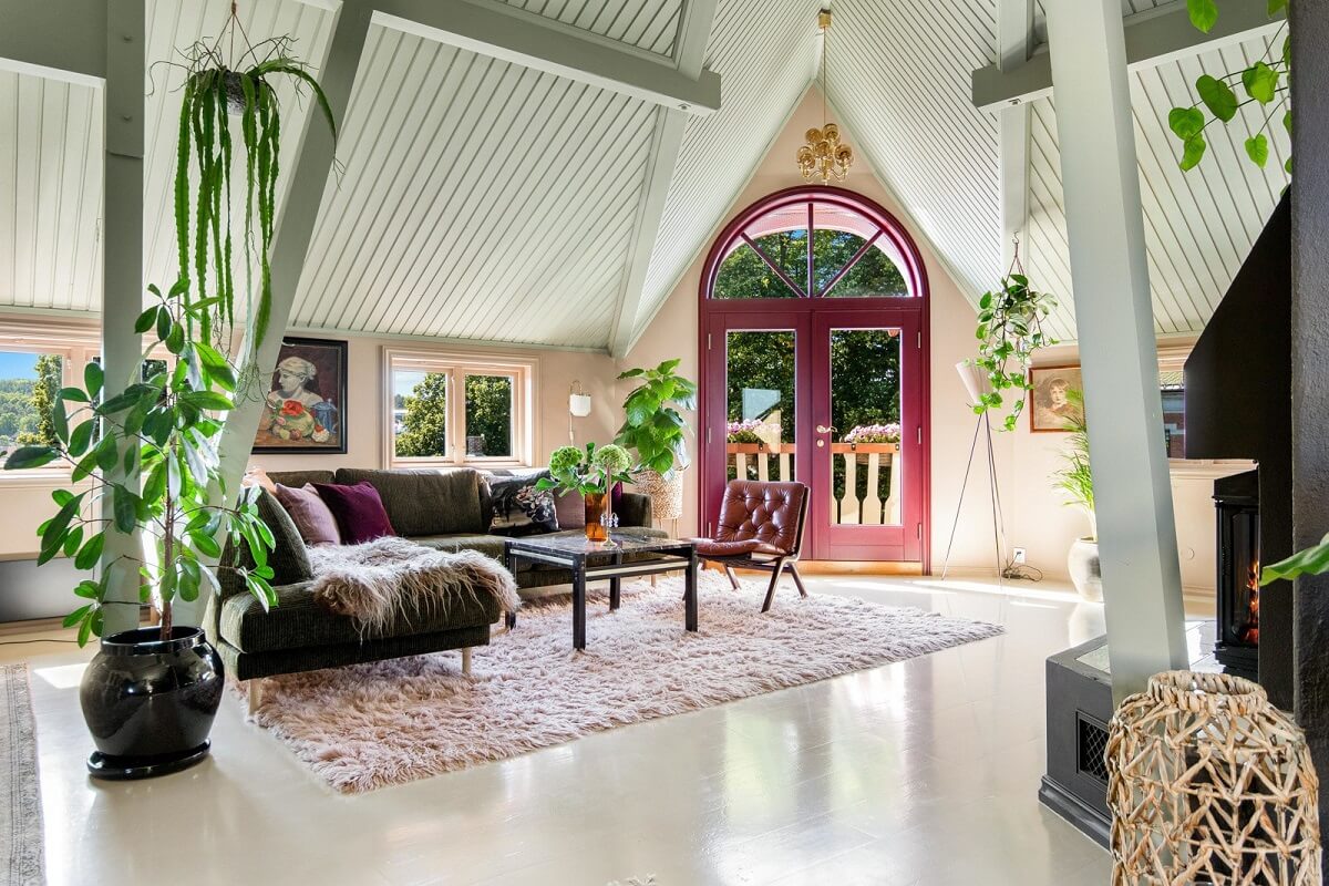 A Charming Attic Apartment Decorated with Color 4 living-room-pink-doors-high-ceiling-nordroom