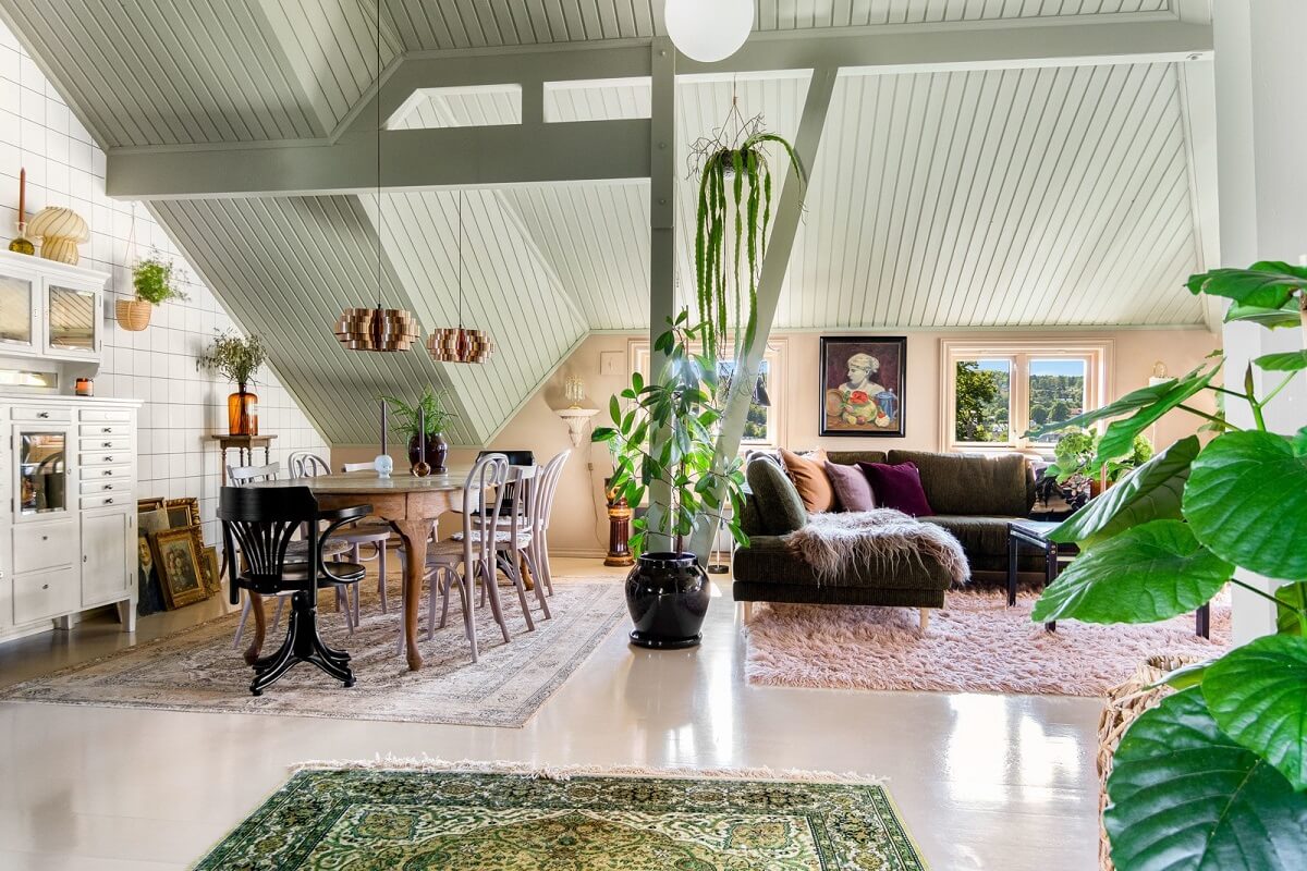 A Charming Attic Apartment Decorated with Color 5 living-space-white-floor-high-slanted-ceiling-green-rug-norwegian-apartment-nordroom