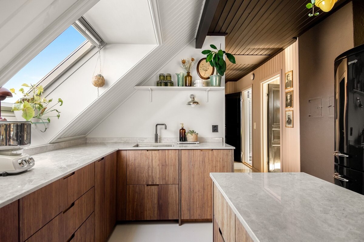 A Charming Attic Apartment Decorated with Color 15 modern-wooden-kitchen-slanted-ceiling-earthy-colored-wall-nordroom