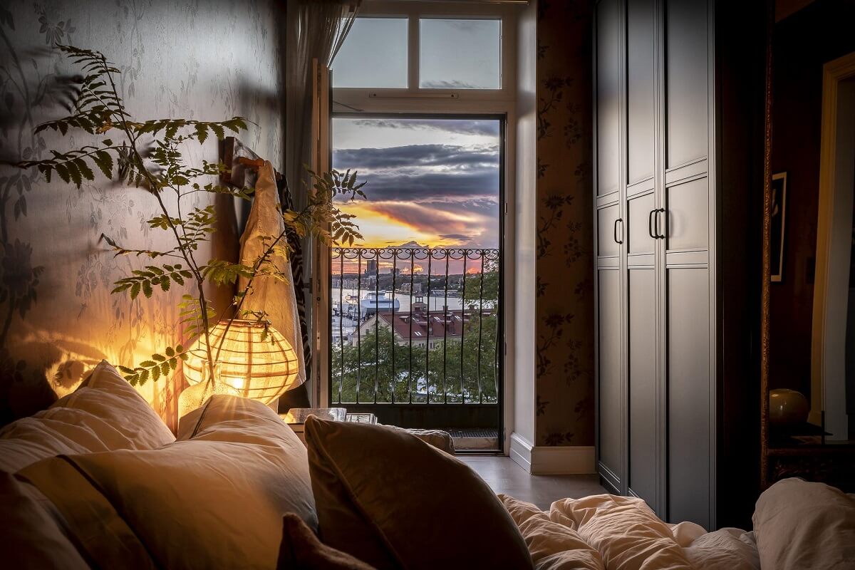 Magical Light in a Stylish Scandinavian Apartment 20 moody-bedroom-black-wardrobes-balcony-nordroom