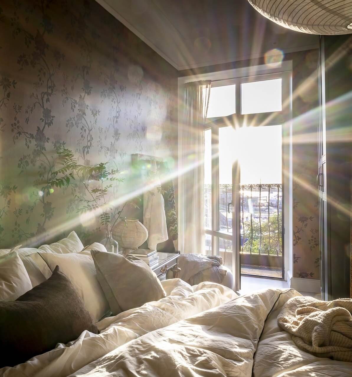 Magical Light in a Stylish Scandinavian Apartment 21 natural-light-master-bedroom-floral-wallpaper-nordroom
