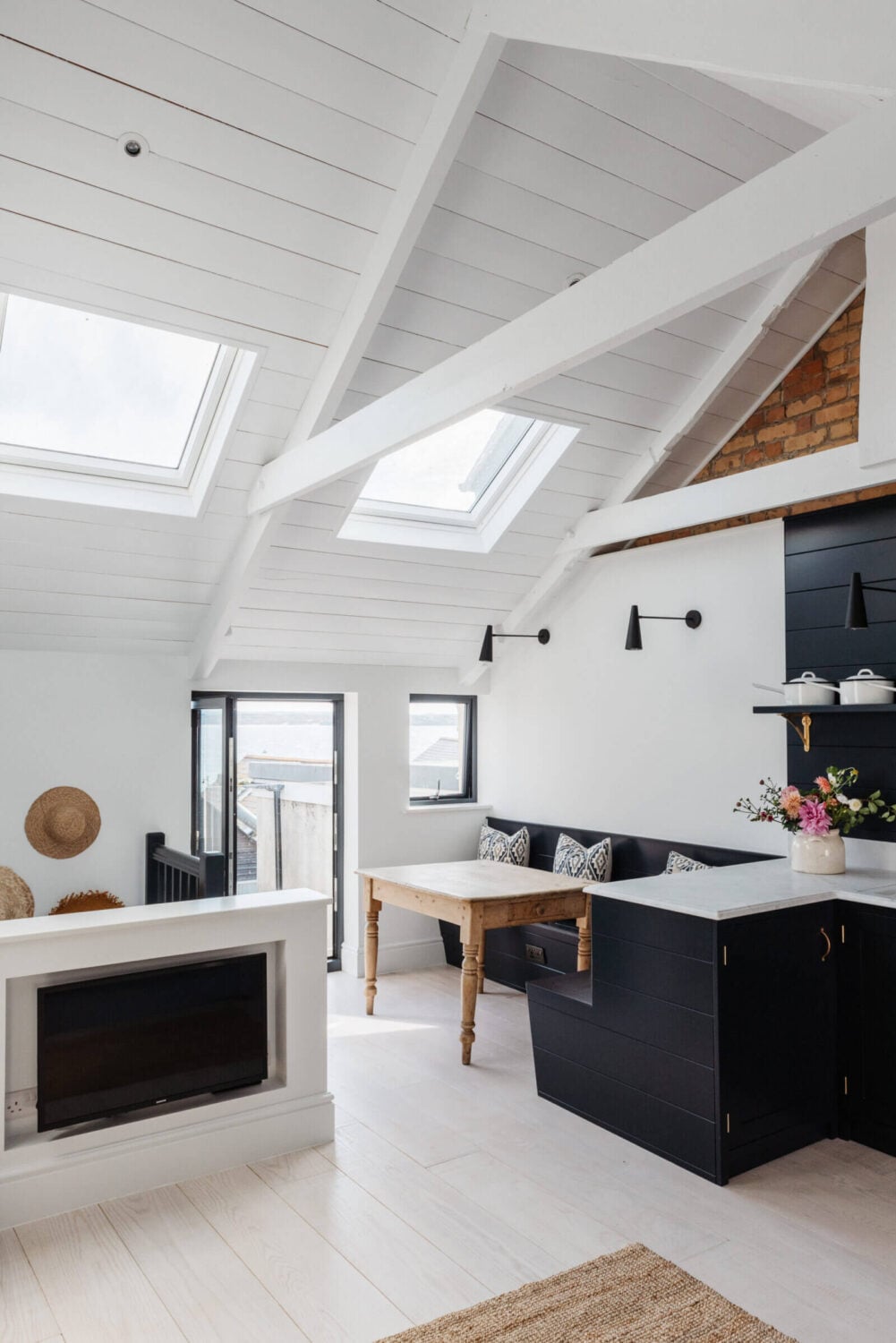 A Beautiful Duplex Apartment in Cornwall 3 open-plan-sitting-room-kitchen-slanted-ceiling-skylights-nordroom