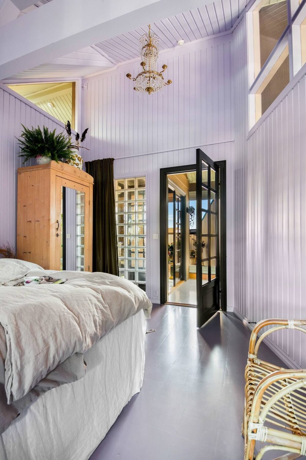 A Charming Attic Apartment Decorated with Color 23 pastel-purple-master-bedroom-high-ceiling-nordroom