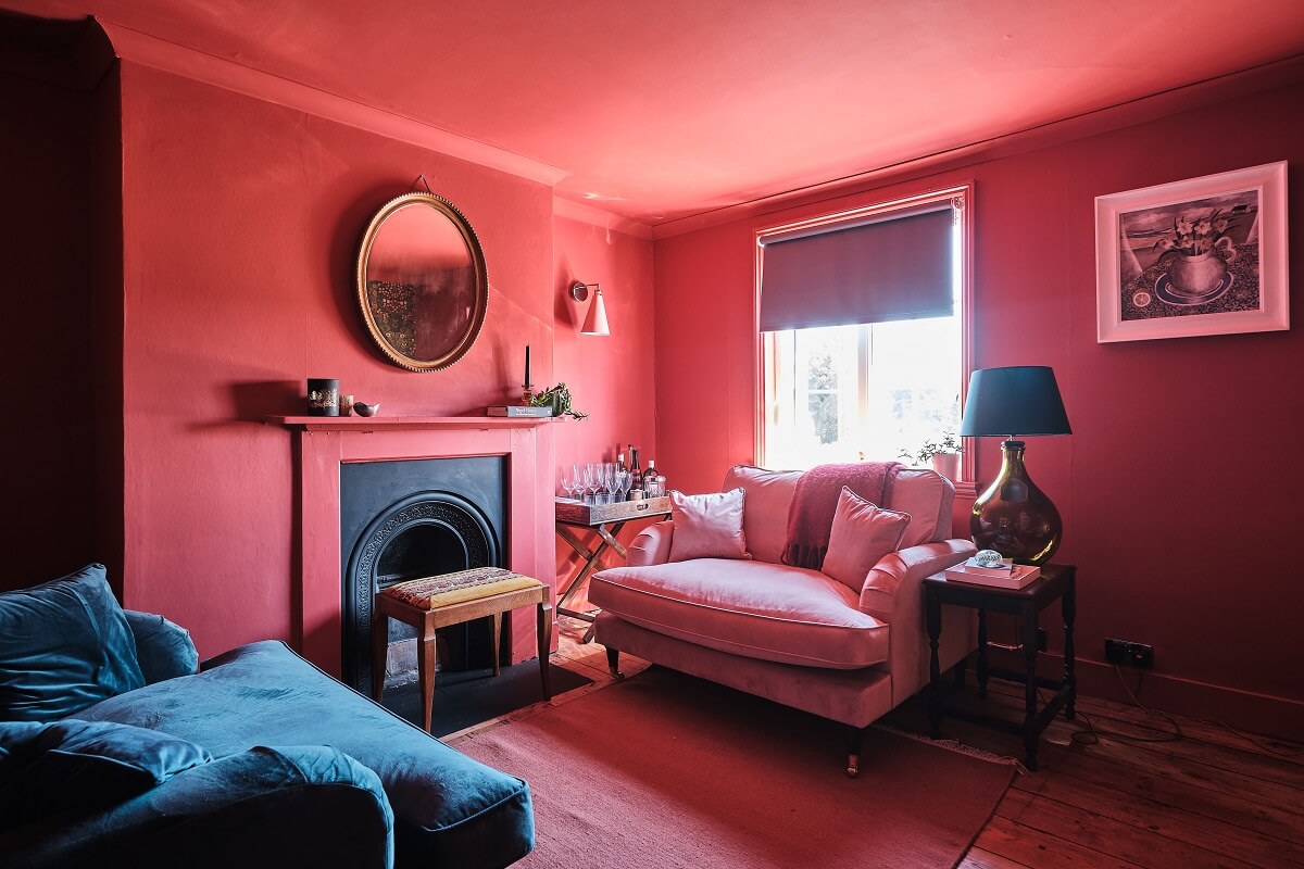 Bold Colors in a Charming English Cottage 10 pink-sitting-room-fireplace-english-cottage-nordroom