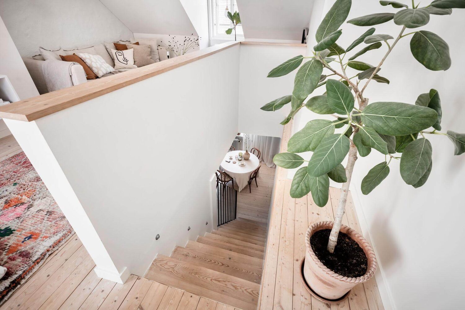 A Living Room with Pink Accents in a Light Attic Apartment 10 staircase-wooden-floor-maisonette-nordroom