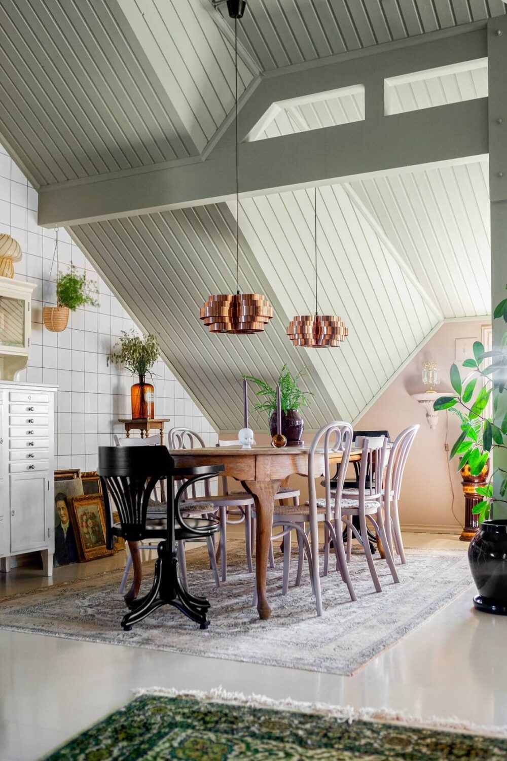 A Charming Attic Apartment Decorated with Color 11 vintage-dining-space-slanted-ceiling-tiled-wall-nordroom
