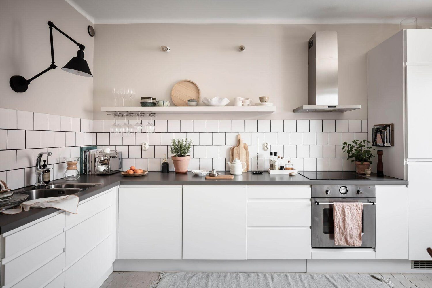 A Living Room with Pink Accents in a Light Attic Apartment 15 white-kitchen-cabinets-tiles-scandinavian-maisonette-nordroom