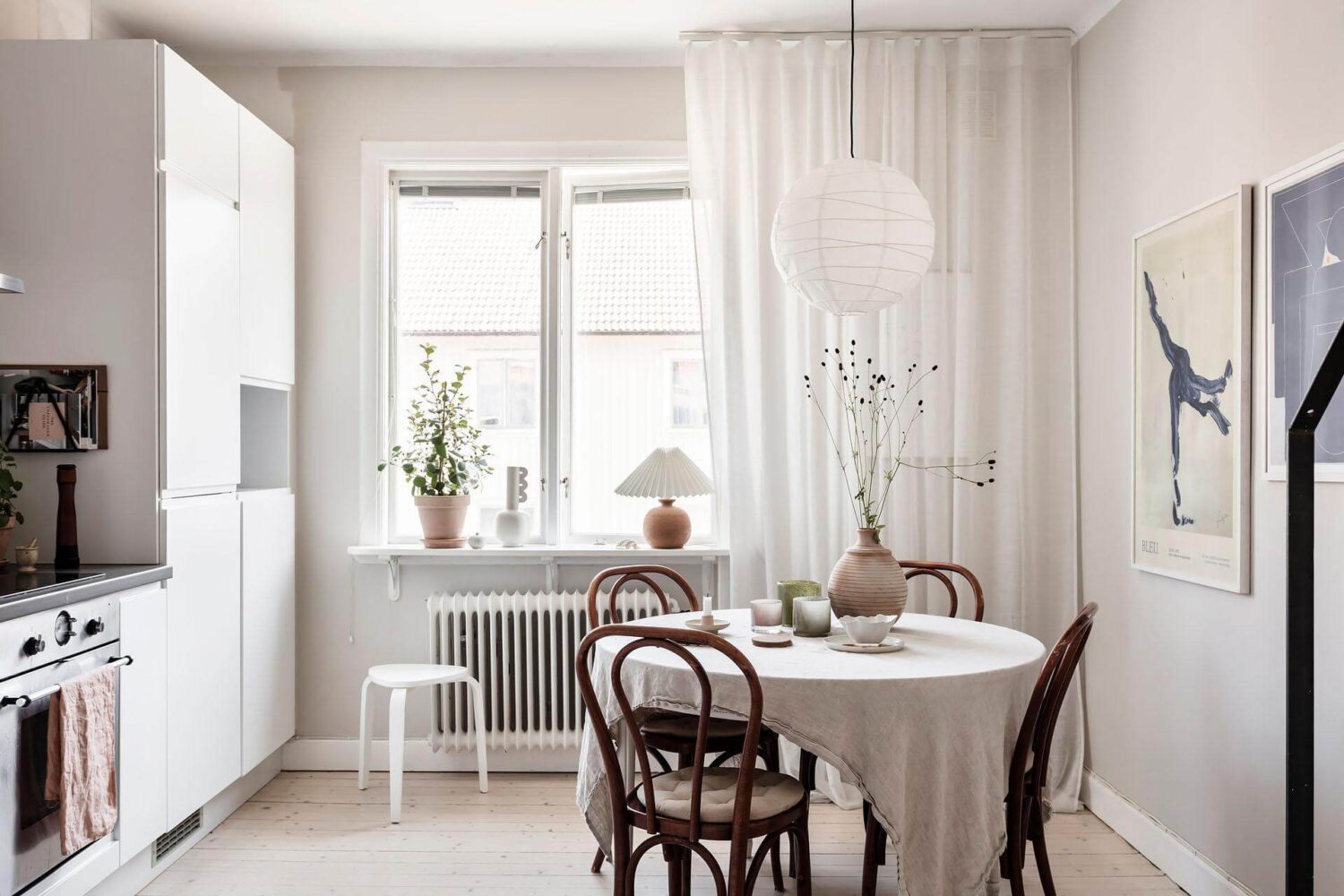 A Living Room with Pink Accents in a Light Attic Apartment 12 white-kitchen-nordic-design-round-dining-table-nordroom