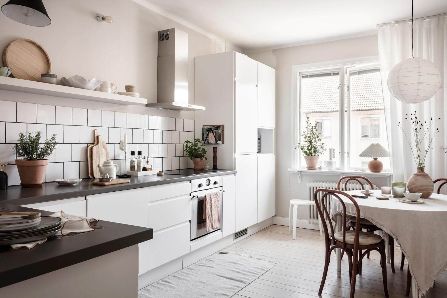 A Living Room with Pink Accents in a Light Attic Apartment 11 white-scandinavian-kitchen-round-dining-table-nordroom