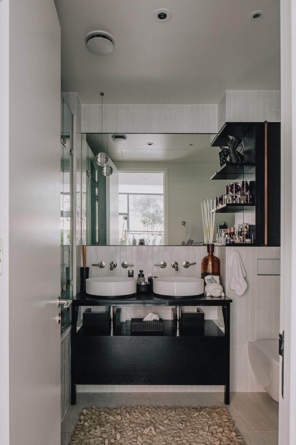 A Modern Apartment in a Former Warehouse in London 11 bathroom-double-round-sink-white-tiles-black-vanity-nordroom