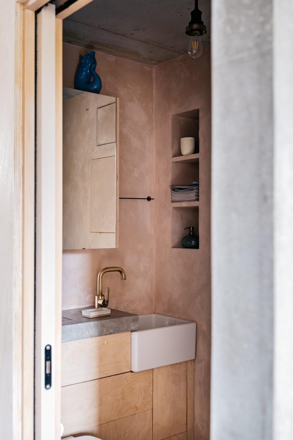A Contemporary Version of a Victorian Terrace House 9 bathroom-pink-plaster-walls-concrete-worktop-storage-niches-nordroom