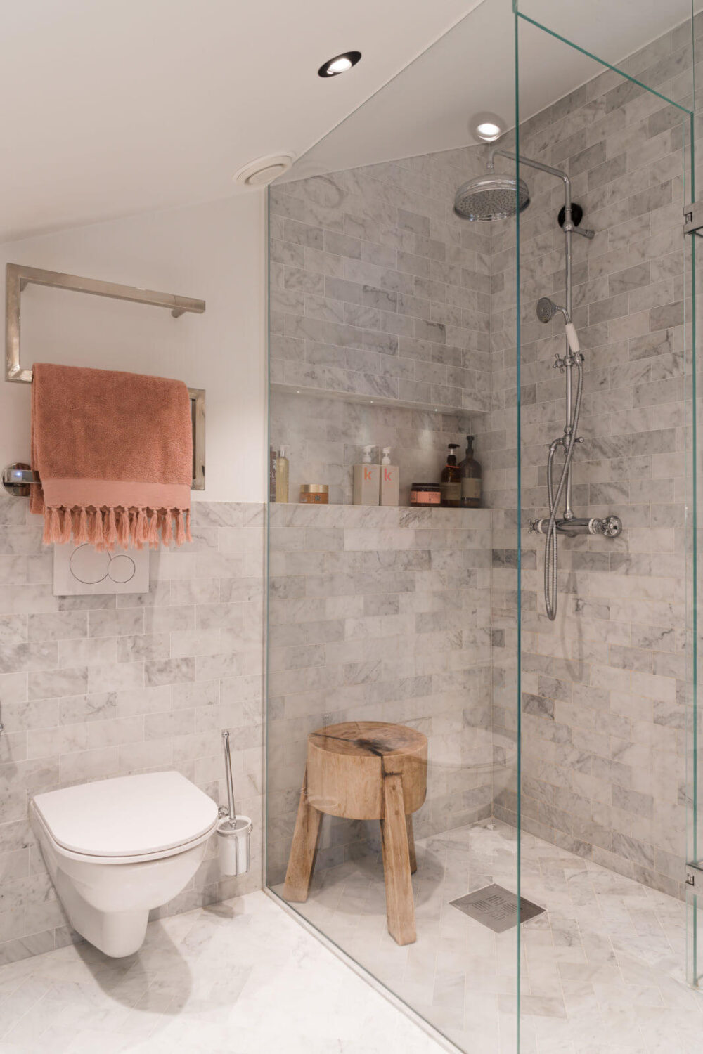 A Small Attic Apartment with Plenty of Storage 13 bathroom-sloped-ceiling-walk-in-shower-carrara-marble-niche-nordroom