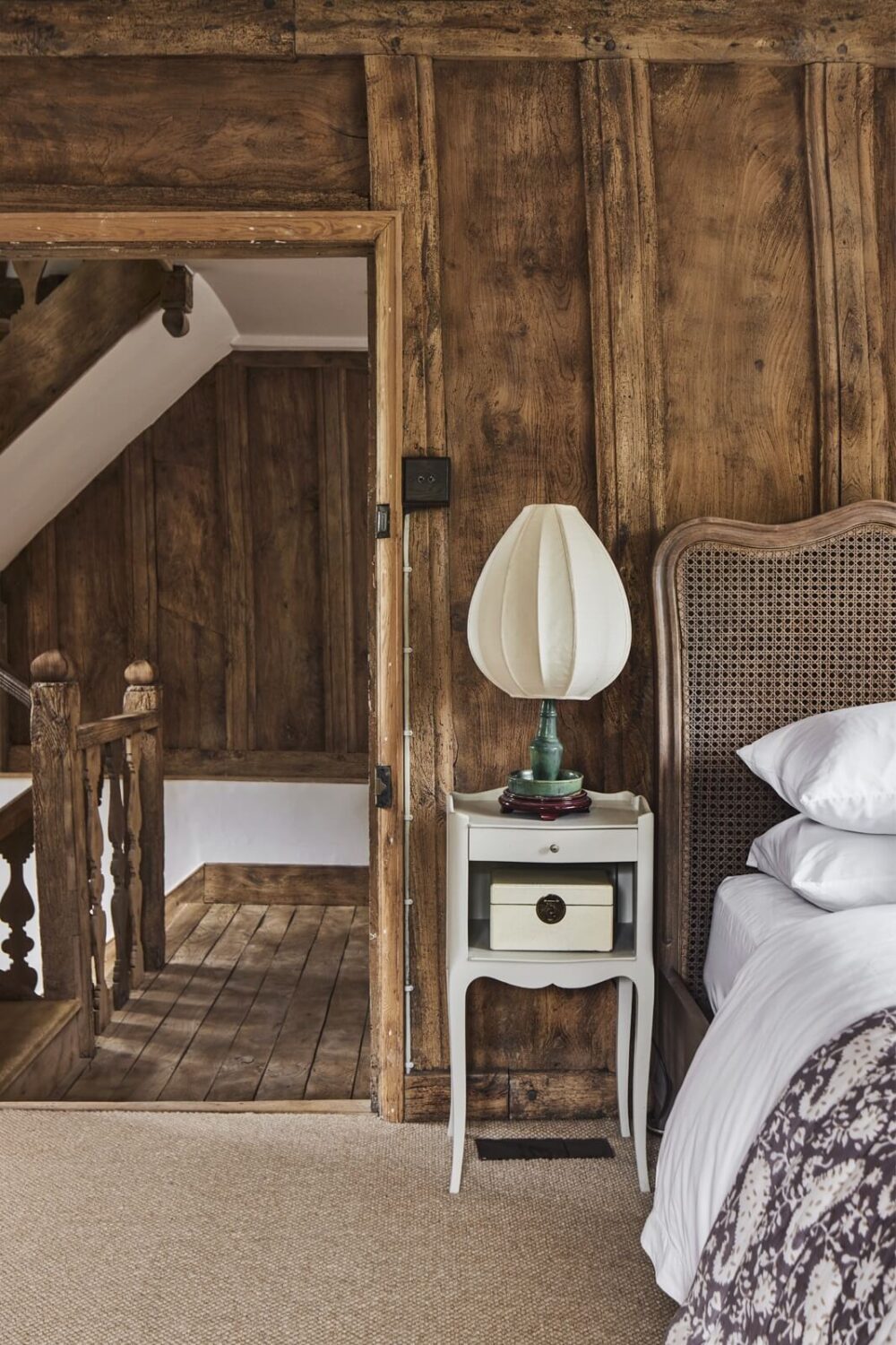 A Restored Elizabethan Manor House in England 16 bedroom-antique-headboard-wooden-walls-nordroom