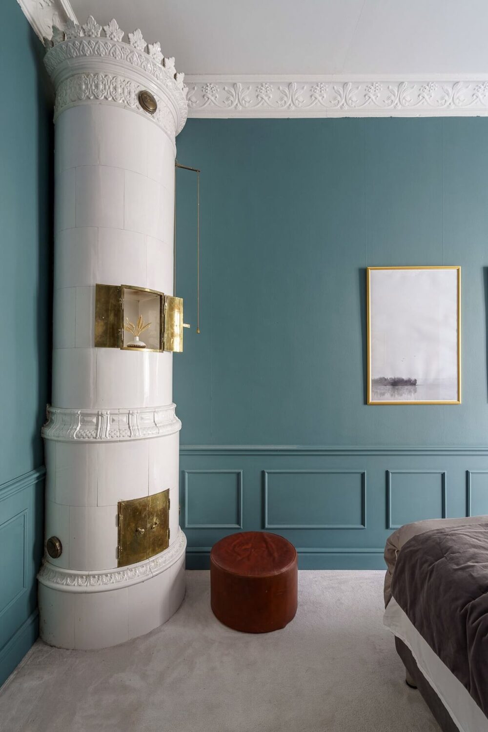 A Classic Nordic Apartment Decorated with Modern Furnishings and Color 14 blue-bedroom-fireplace-red-pouf-nordroom