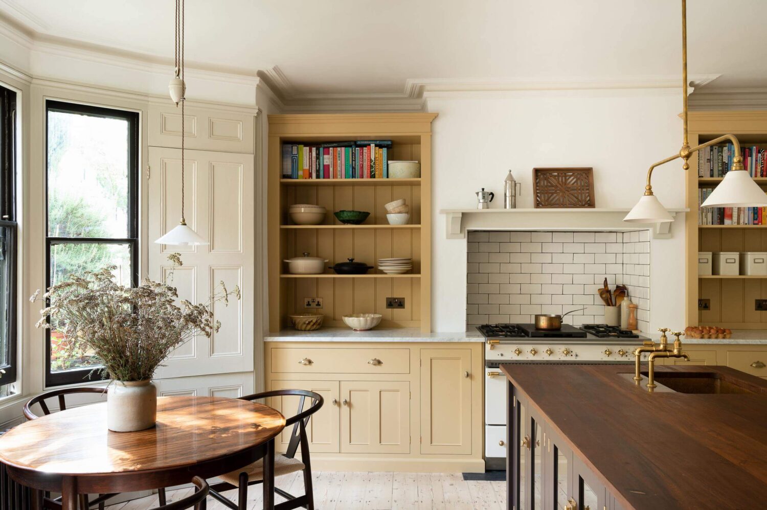 A deVOL Kitchen with Butter Yellow Cabinets 2 devol-kitchen-yellow-brown-cabinets-round-table-bay-window-nordroom