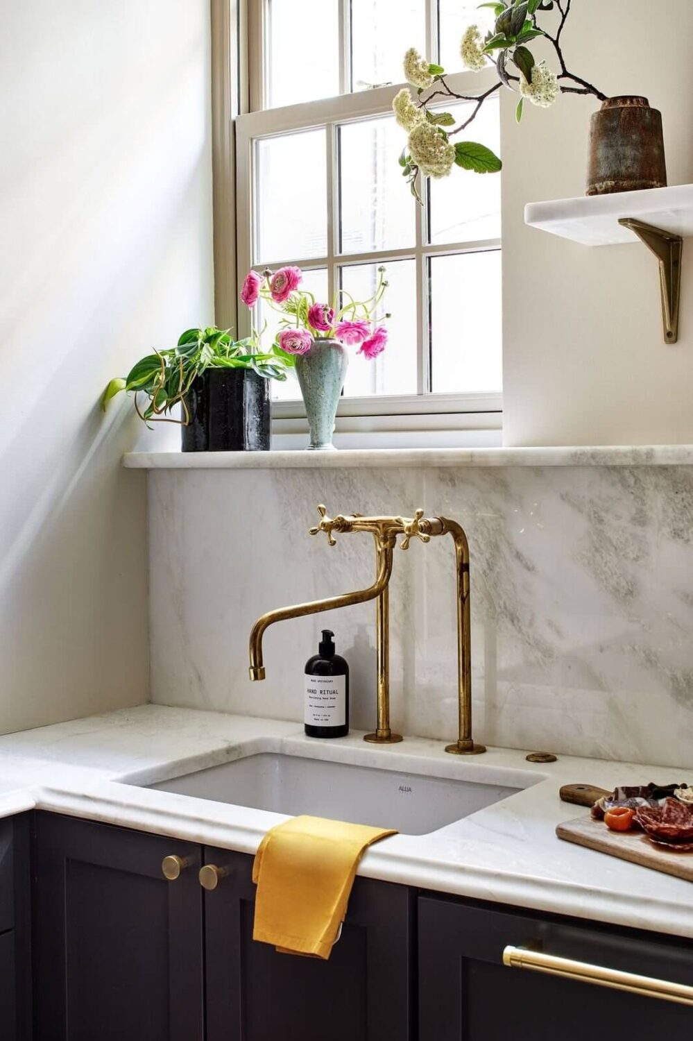 Bold Colors in a Washington D.C. Pied-à-Terre 5 galley-kitchen-marble-backsplash-window-nordroom