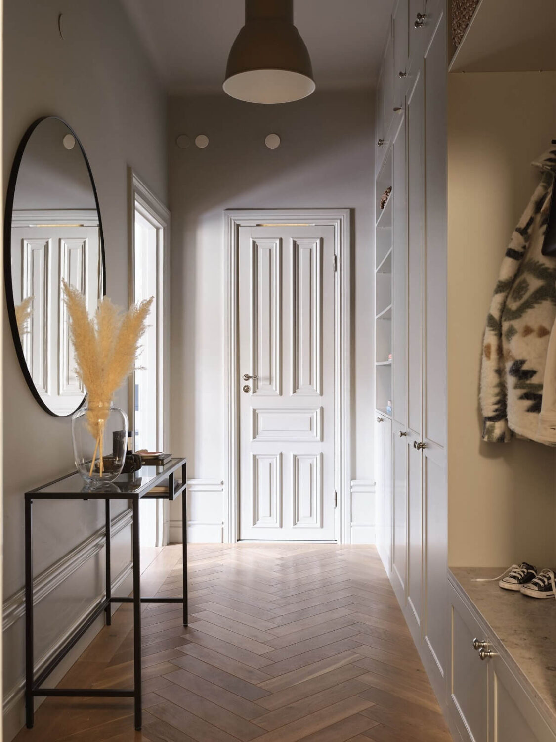 A Stylish Nordic Apartment with Attic Bedroom 26 hallway-built-in-cabinets-niche-coat-storage-round-mirror-nordroom