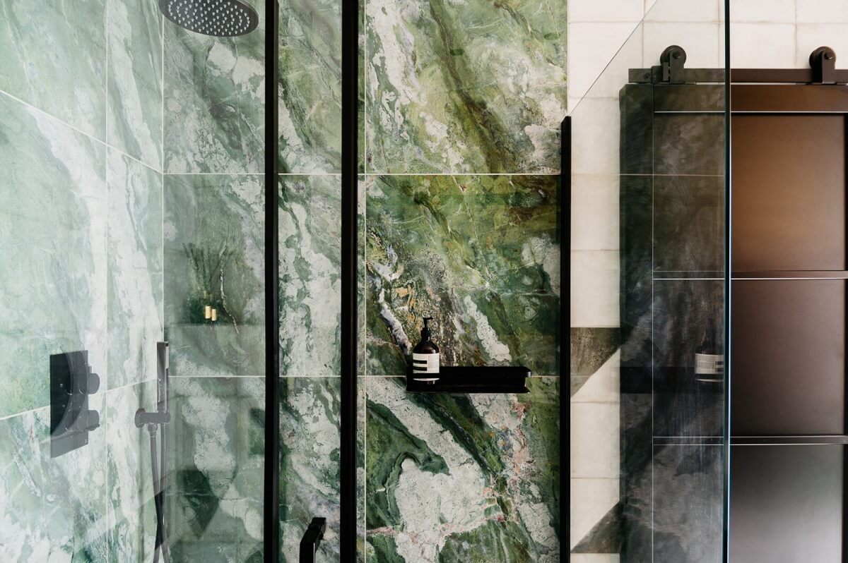 A Modern Apartment with Exposed Brick Walls and Color Accents 15 industrial-style-bathroom-green-marble-tiles-nordroom