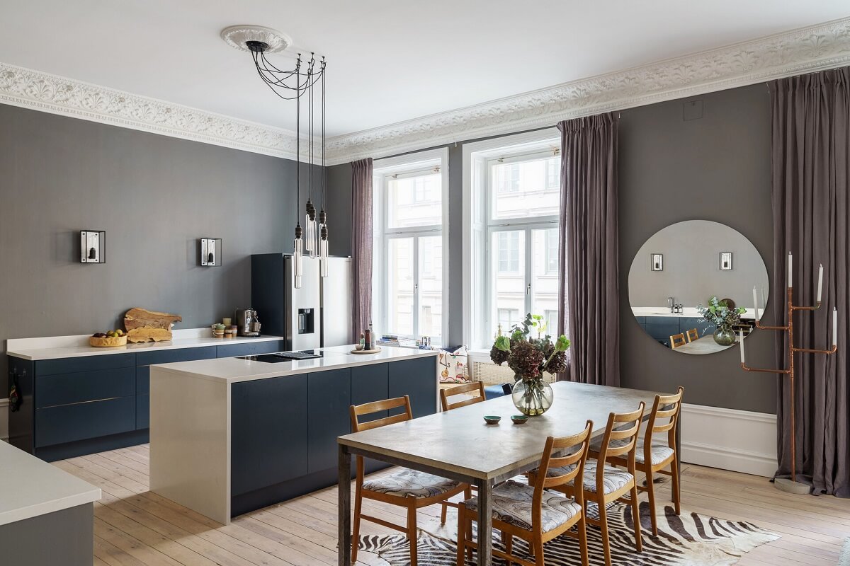 A Classic Nordic Apartment Decorated with Modern Furnishings and Color 9 kitchen-blue-cabinets-dining-table-round-mirror-nordroom