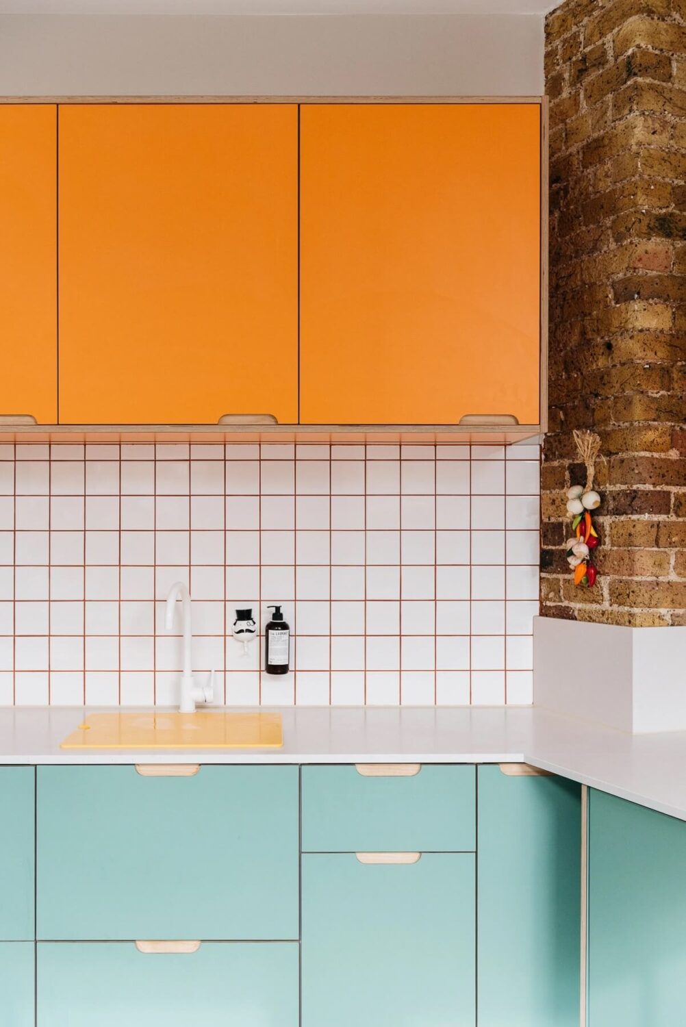 57 Stylish Two-Tone Kitchen Cabinet Ideas 50 kitchen-blue-orange-cabinets-brick-wall-warehouse-apartment-london-nordroom