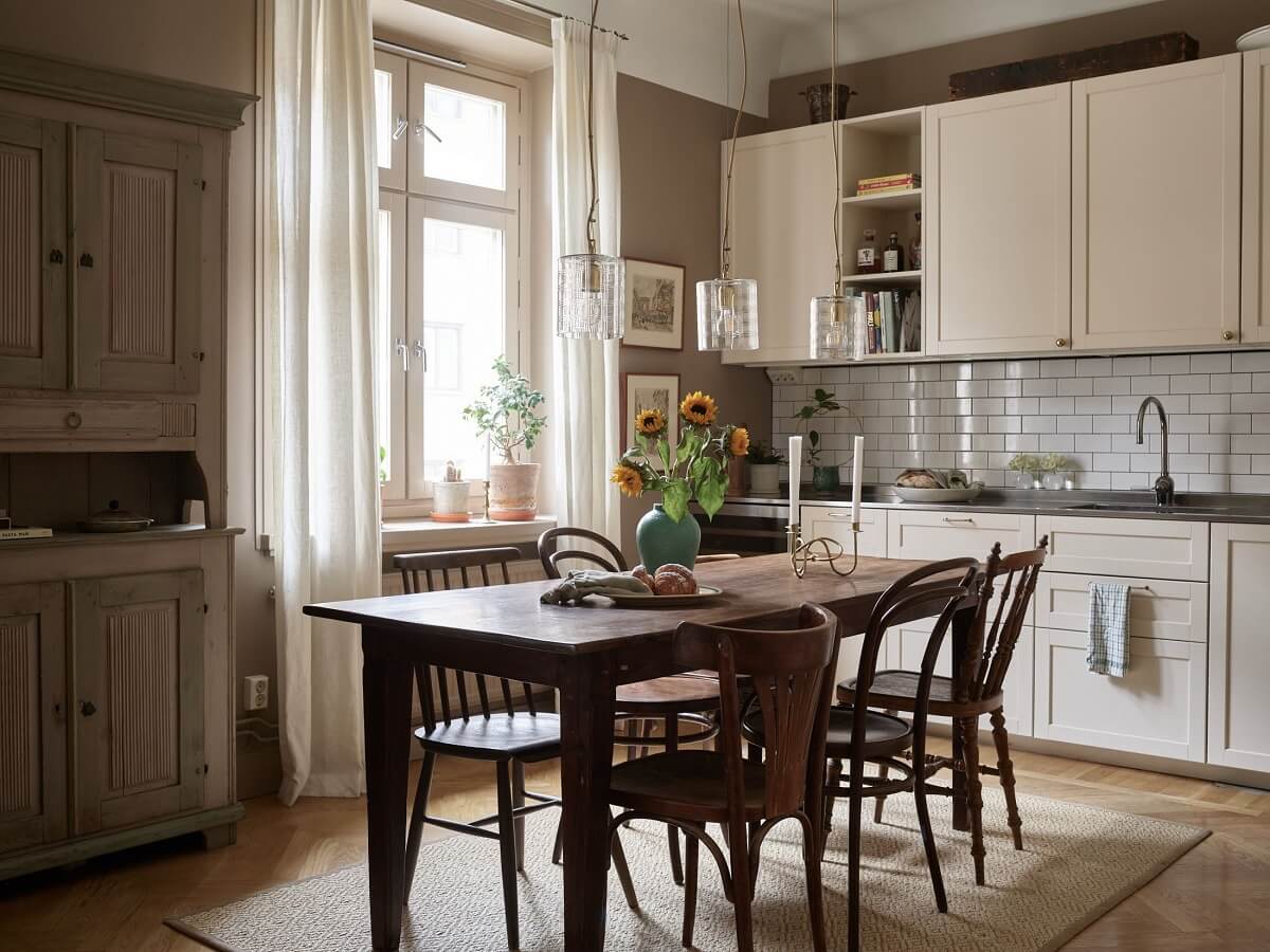 A Warm Nordic Apartment with Light Brown Walls 7 kitchen-dining-space-rustic-wooden-table-norroom