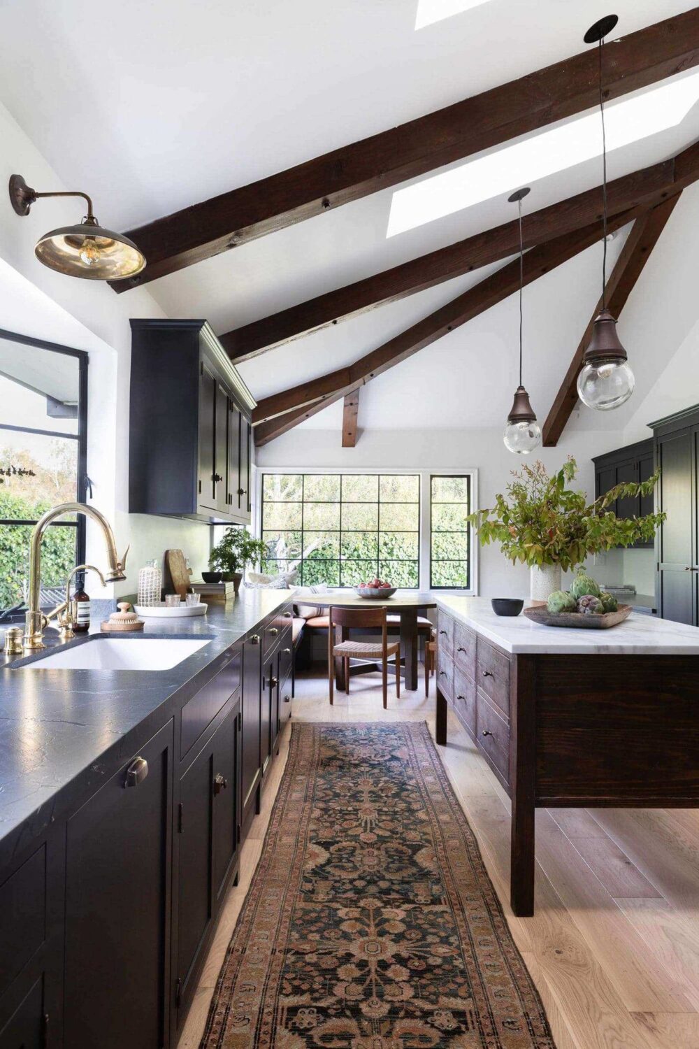 Beautiful Kitchens with Skylights That Add Light and Style 1 kitchen-island-large-rug-round-dining-table-wooden-beams-skylight-nordroom