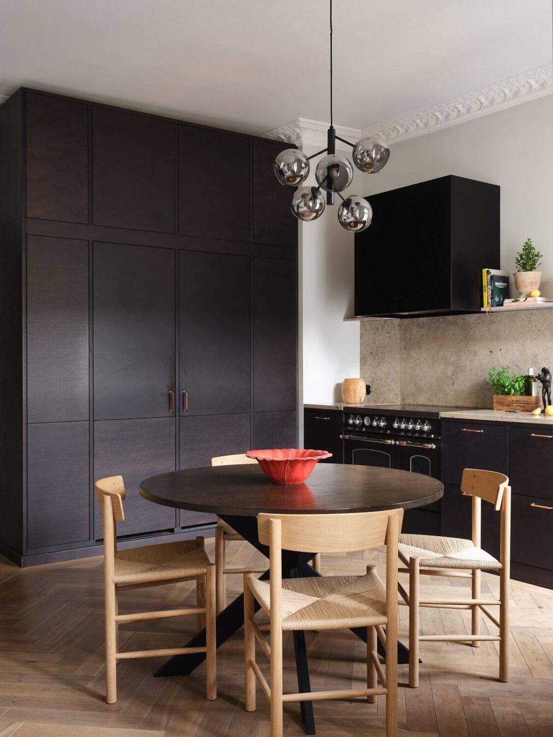 A Stylish Nordic Apartment with Attic Bedroom 9 kitchen-round-dining-table-dark-cupboards-floor-to-ceiling-cabinets-nordroom