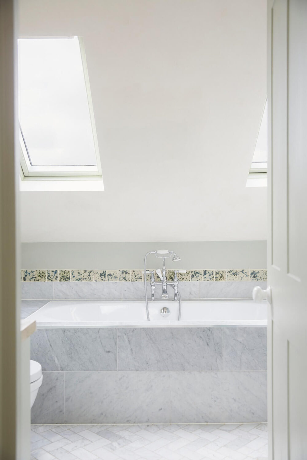 A Colorful Eclectic House Designed by Alice Palmer 18 light-bathroom-sloped-ceiling-bath-carrara-marble-nordroom