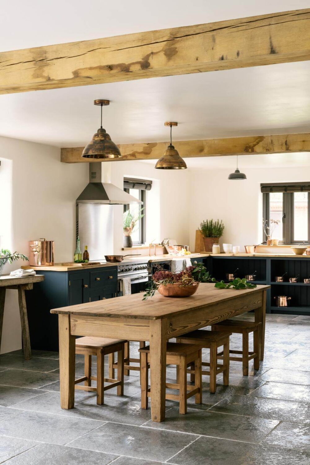 31 Practical Kitchen Flooring Ideas For Your Home 12 limestone-floor-kitchen-rustic-island-exposed-beams-nordroom