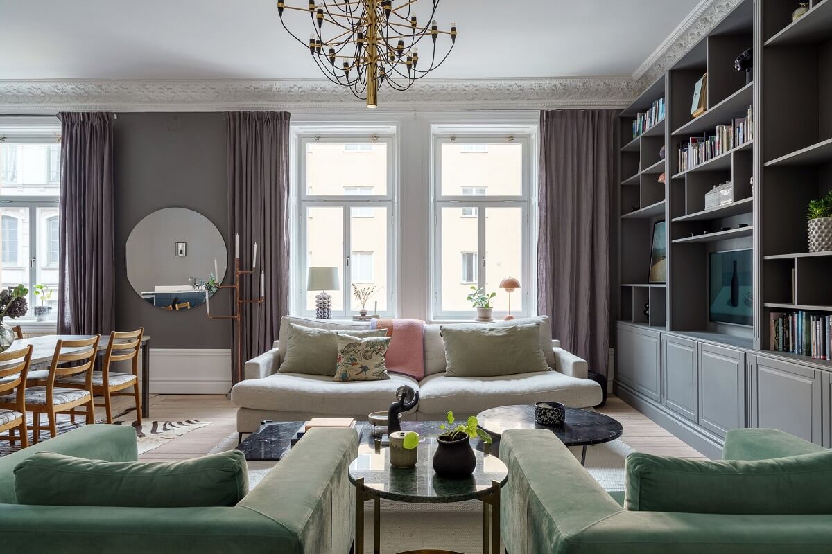 A Classic Nordic Apartment Decorated with Modern Furnishings and Color 4 living-room-bookcases-round-mirror-nordroom