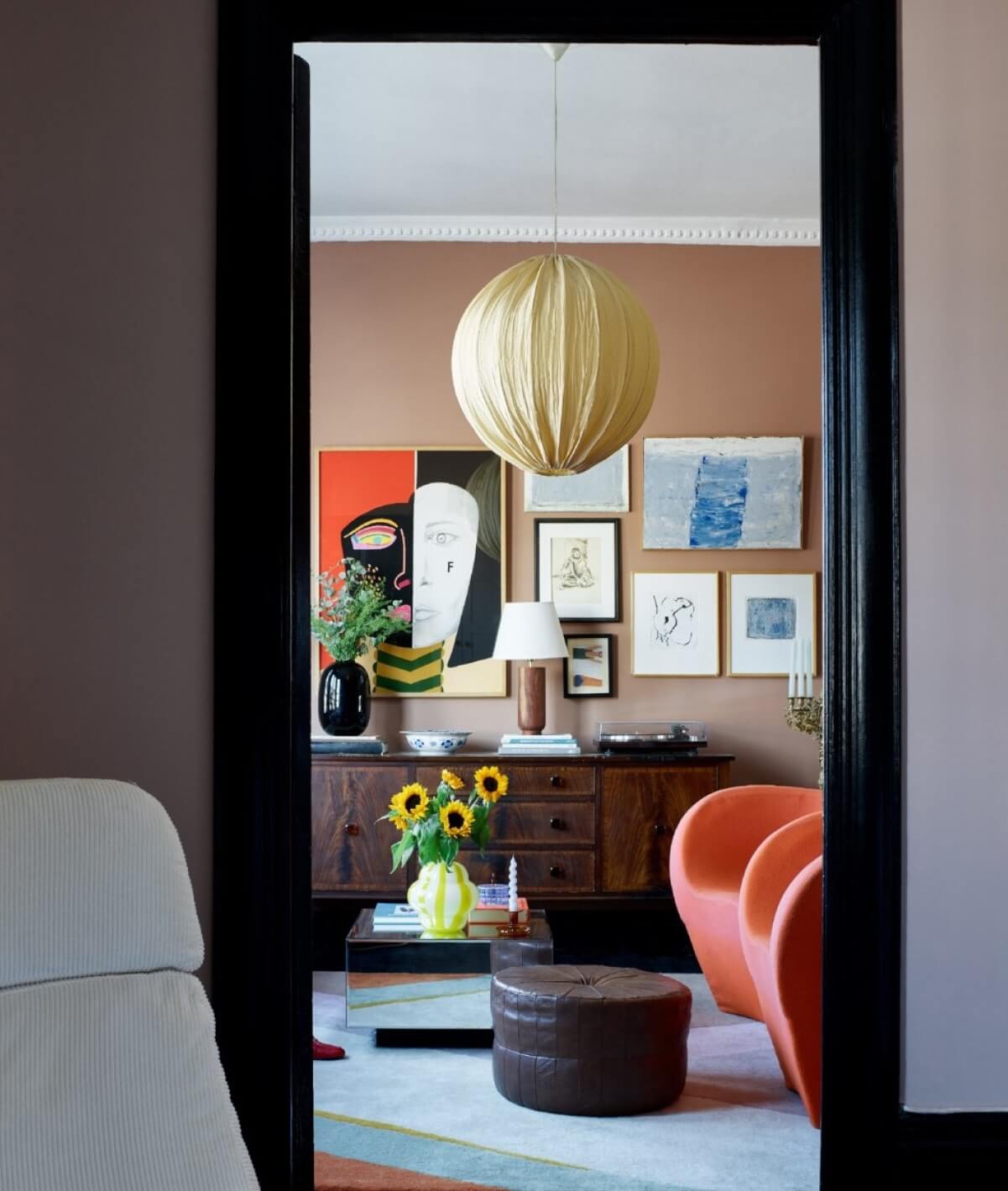 A Colorful Nordic Apartment with Dusty Pink Walls 10 living-room-orange-armchairs-gallery-wall-nordroom