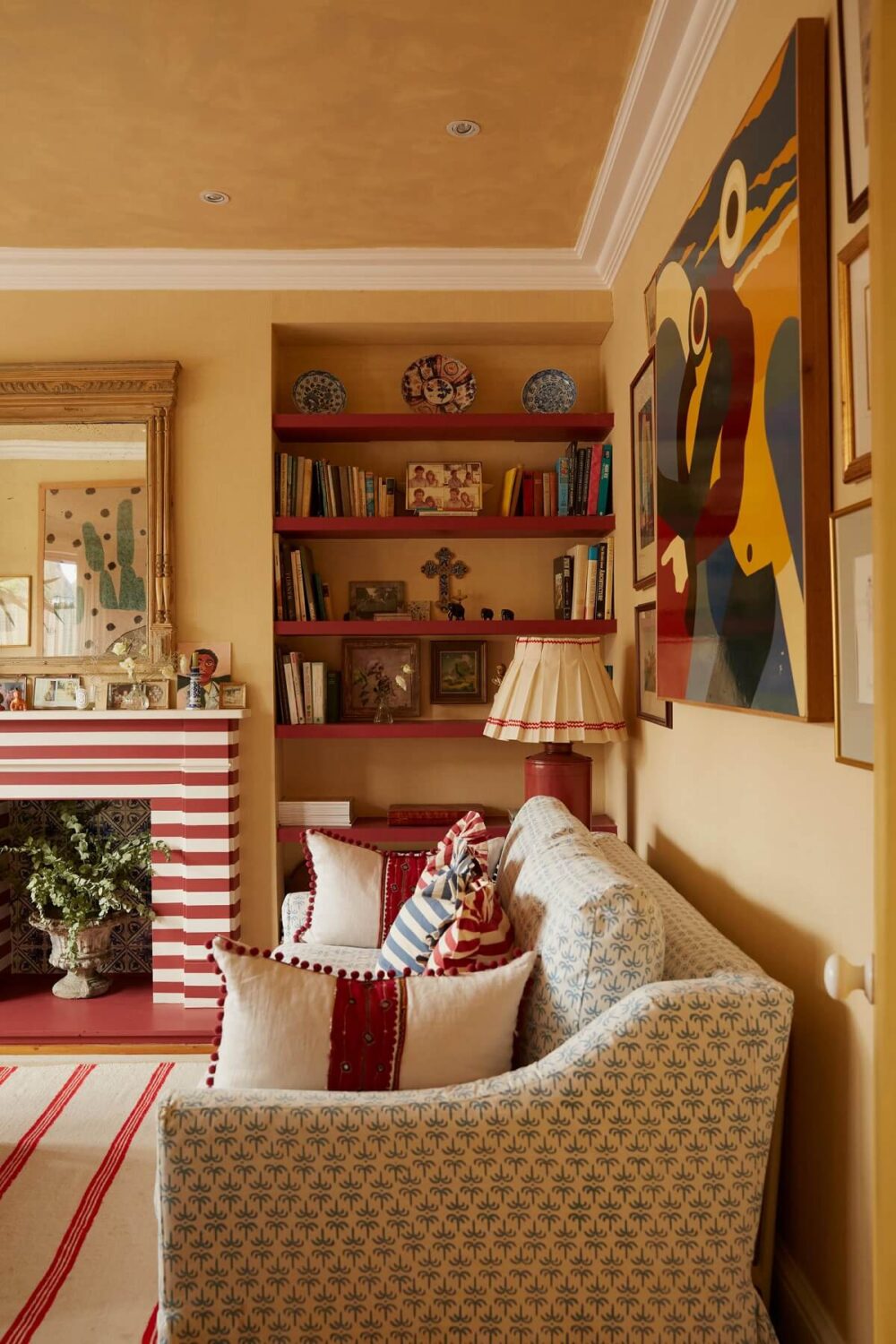A Colorful Eclectic House Designed by Alice Palmer 8 living-room-red-color-accents-built-in-bookshelves-fireplace-nordroom