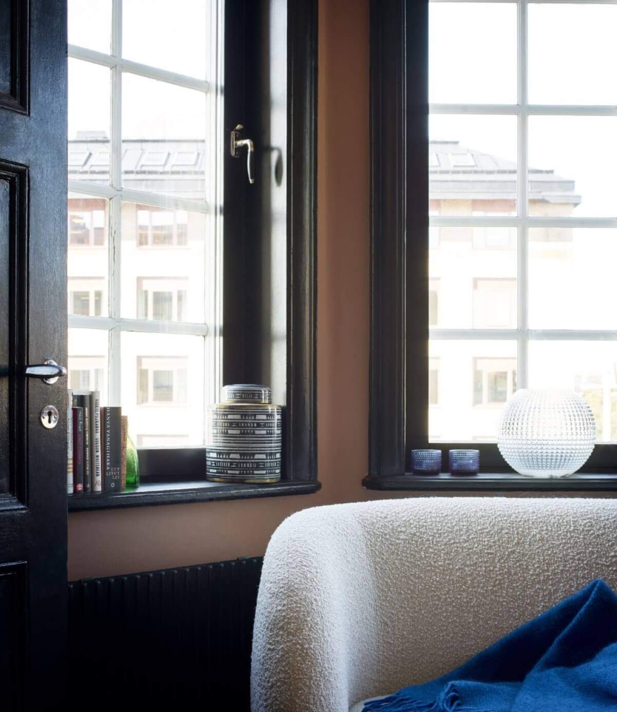 A Colorful Nordic Apartment with Dusty Pink Walls 7 living-room-windows-black-trimmings-nordroom