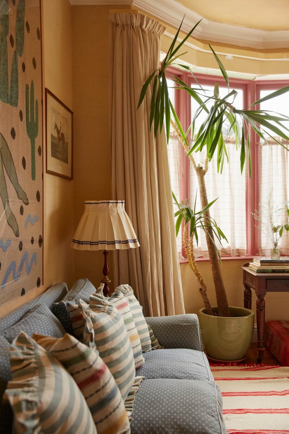 A Colorful Eclectic House Designed by Alice Palmer 11 living-room-yellow-walls-ceiling-red-window-frames-nordroom