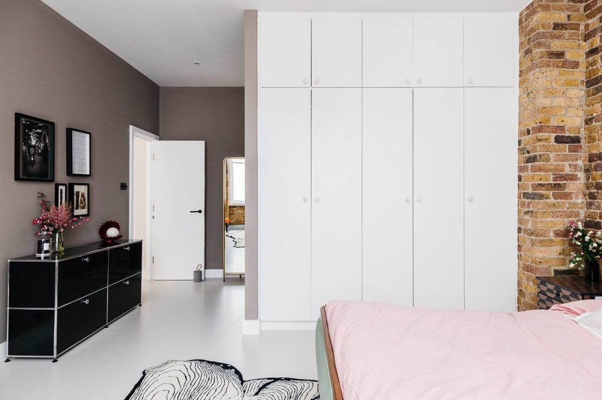 A Modern Apartment with Exposed Brick Walls and Color Accents 11 master-bedroom-brick-walls-white-wardrobes-nordroom