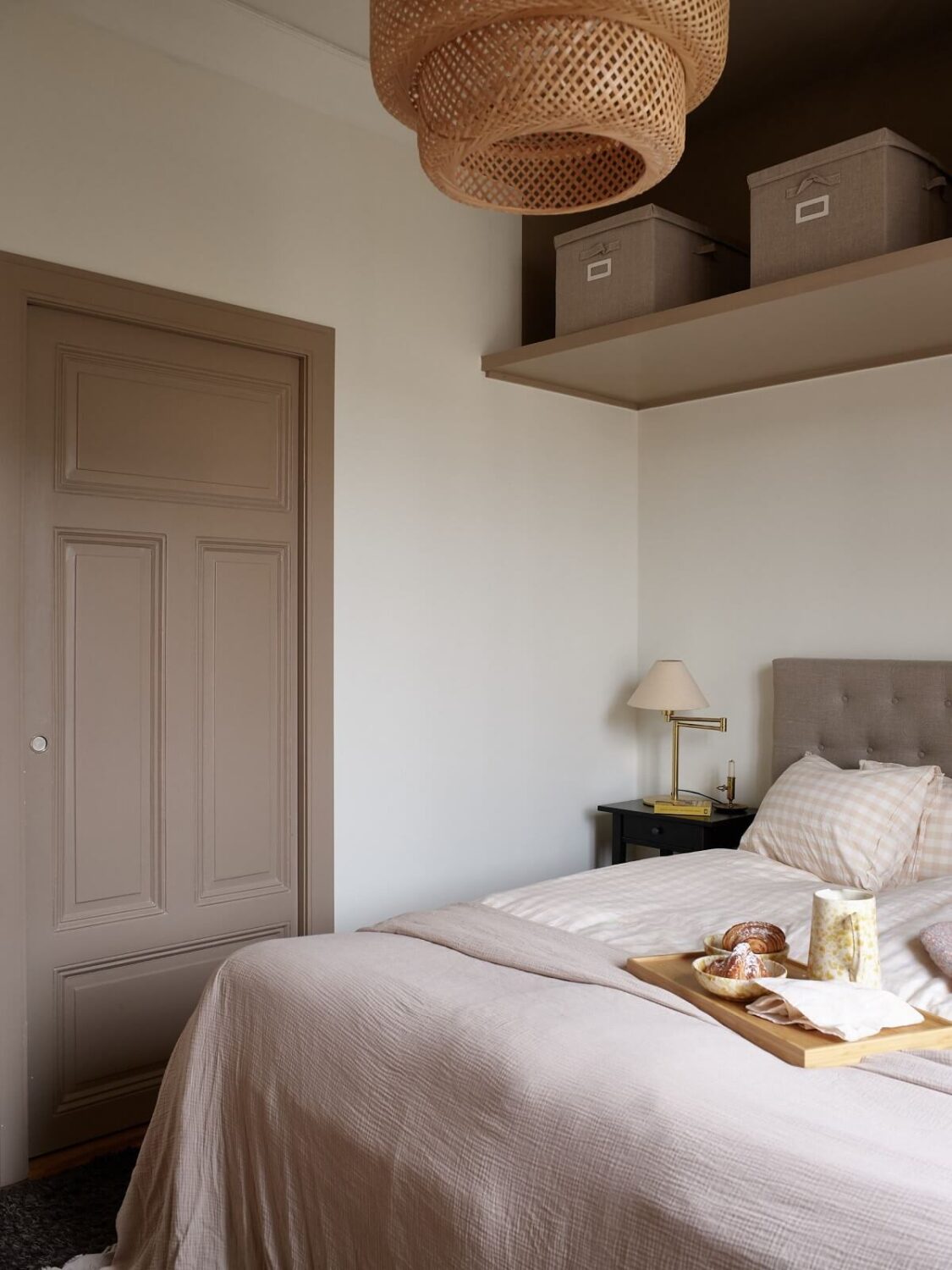 A Warm Nordic Apartment with Light Brown Walls 14 master-bedroom-shelf-above-bed-light-brown-accent-color-nordroom