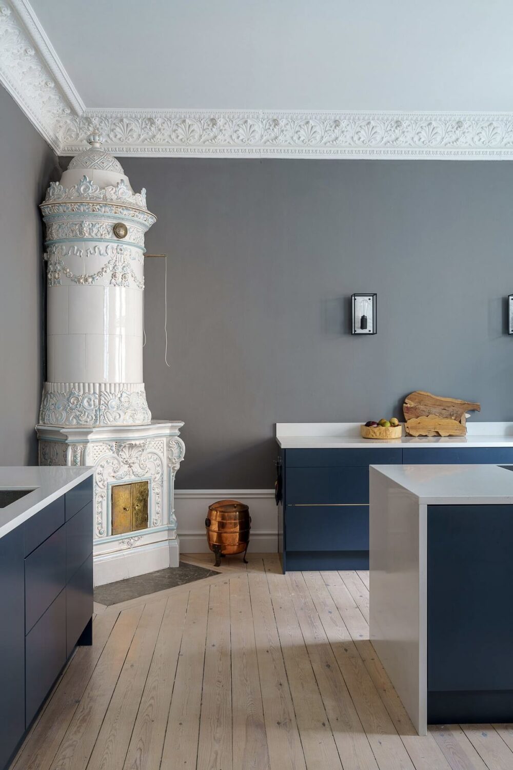 A Classic Nordic Apartment Decorated with Modern Furnishings and Color 11 modern-kitchen-blue-cabinets-fireplace-gray-walls-nordroom