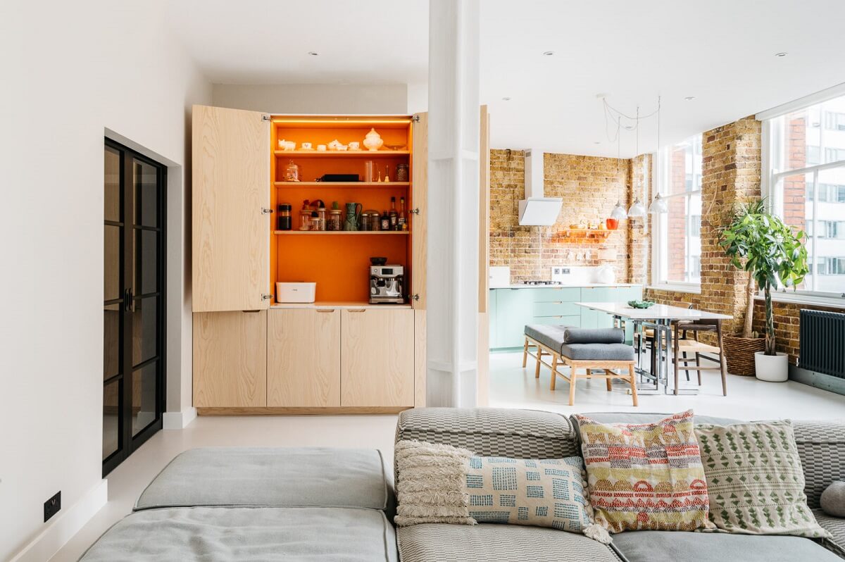 A Modern Apartment with Exposed Brick Walls and Color Accents 8 modern-warehouse-apartment-orange-cabinet-nordroom