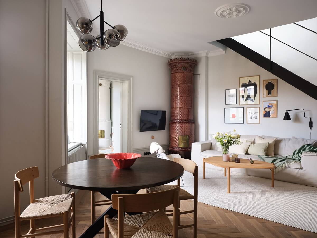 open-plan-living-room-kitchen-round-dining-table-brown-fireplace-nordroom