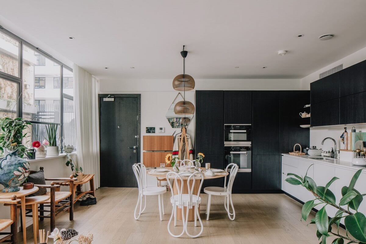 A Modern Apartment in a Former Warehouse in London 5 open-plan-living-space-round-dining-table-black-white-kitchen