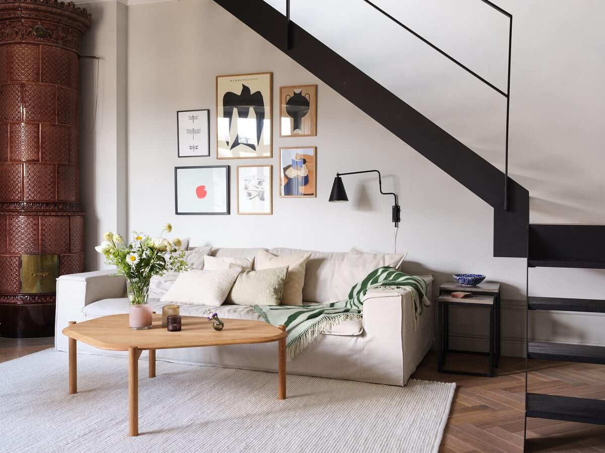 A Stylish Nordic Apartment with Attic Bedroom 5 sitting-area-under-black-staircase-brown-fireplace-nordroom