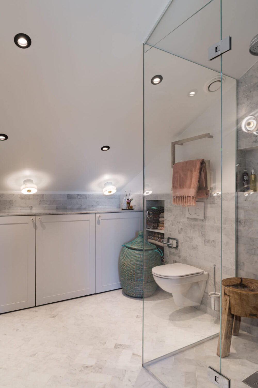 A Small Attic Apartment with Plenty of Storage 14 small-bathroom-slanted-ceiling-storage-cabinets-nordroom