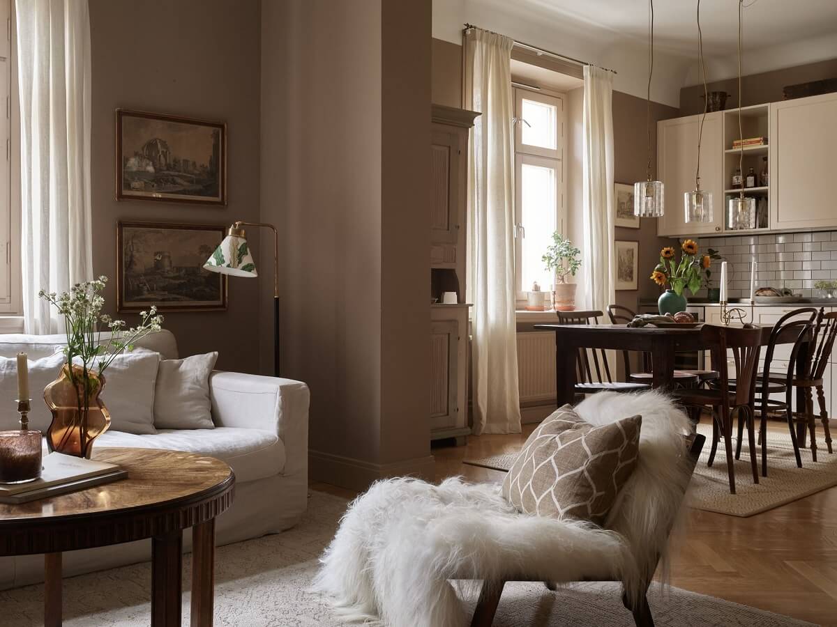 A Warm Nordic Apartment with Light Brown Walls 9 warm-sitting-room-brown-walls-antique-art-nordroom