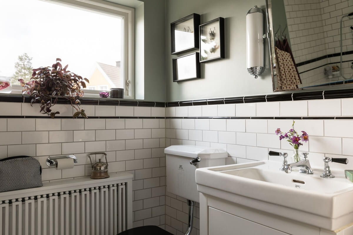 A Scandinavian Home with Purple Color Accents 24 bathroom-white-tiles-gray-walls-nordroom