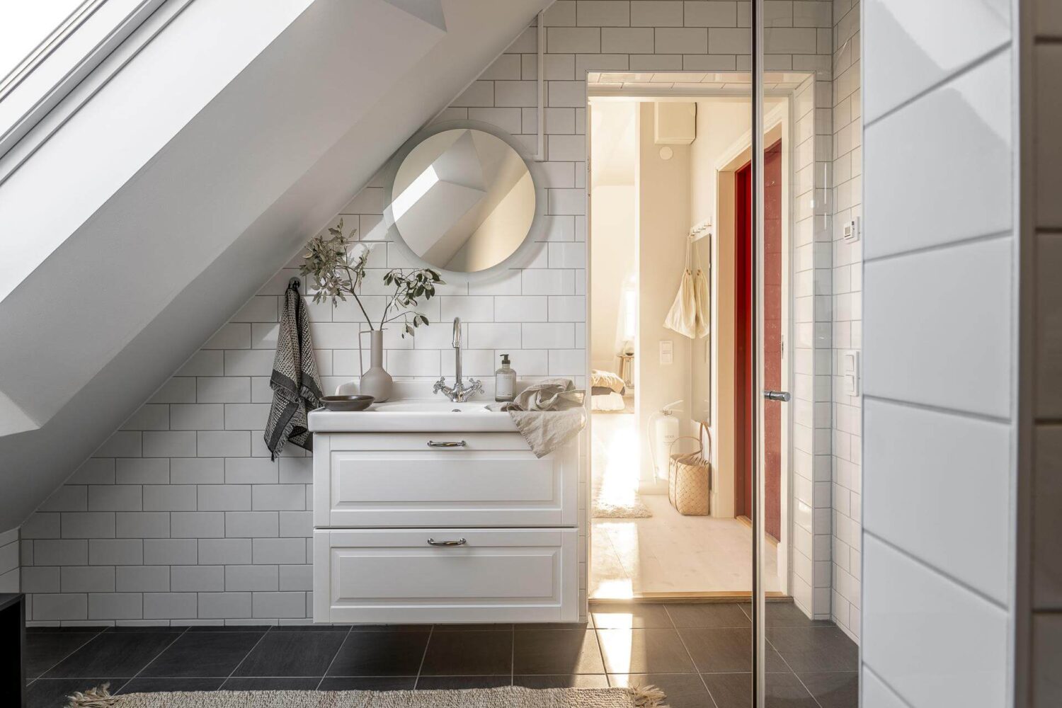 A Small Scandinavian Loft with Beautiful Natural Light 14 bathroom-white-tiles-slanted-ceiling-nordroom