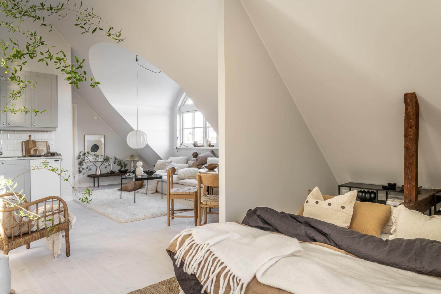 A Small Scandinavian Loft with Beautiful Natural Light 13 bedroom-area-loft-slanted-ceiling-exposed-wooden-beams-nordroom