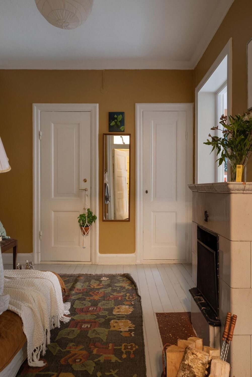 A Cozy Apartment Painted in Warm Natural Colors 10 bedroom-fireplace-earth-colored-walls-rug-nordroom