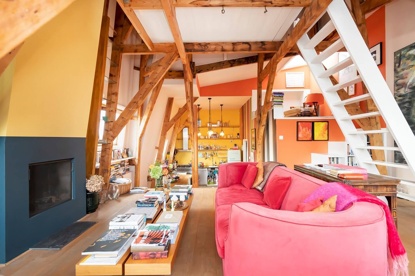 A Colorful Loft in Amsterdam with Exposed Wooden Beams 6 colorful-loft-apartment-pink-sofa-fireplace-nordroom