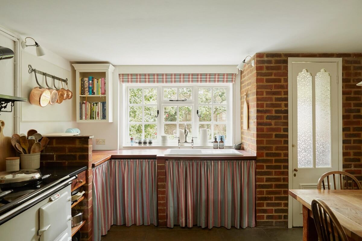 A Charming Arts and Crafts Cottage in the English Countryside 8 cottage-kitchen-aga-stove-skirting-exposed-brick-walls-nordroom
