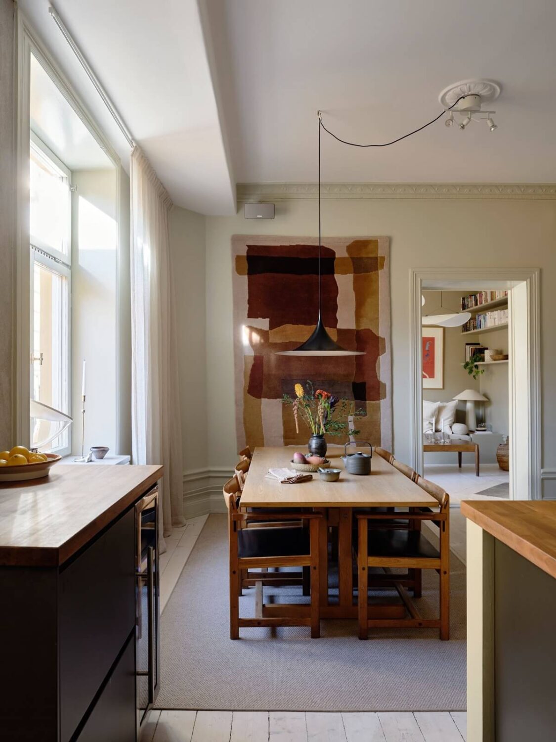 A Nordic Maisonette That Makes The Most Of Its Awkward Nooks 10 dining-room-black-kitchen-large-colorful-art-nordroom